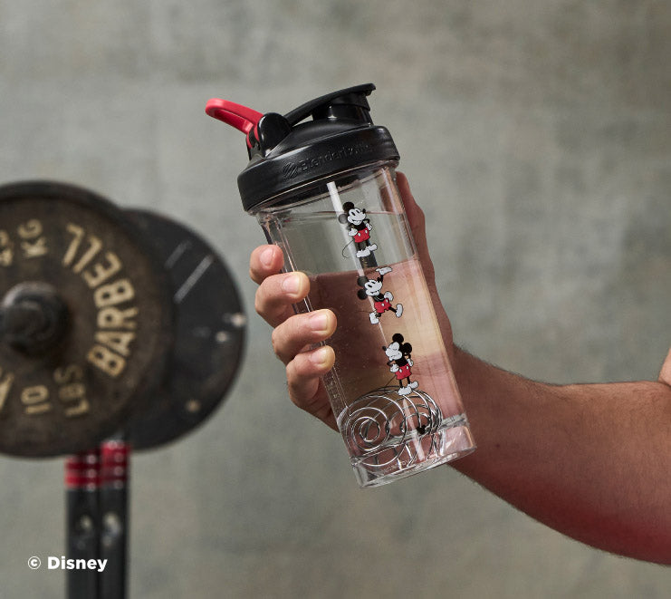 pro-series-k5 Mickey_Mouse_Protein_Shaker_Bottle_Being_Held_In_the_Gym.jpg